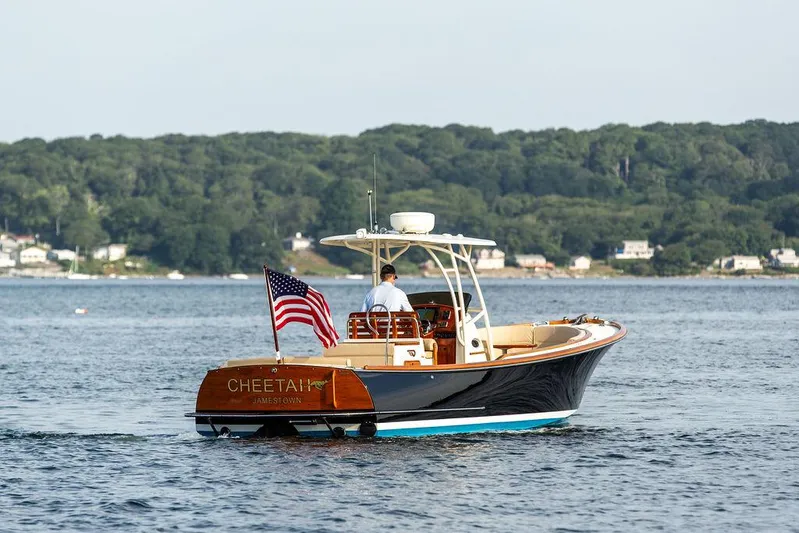 Cheetah Yacht Photos Pics 2014 Hinckley T29 CC boat cruising on a scenic lake with American flag.