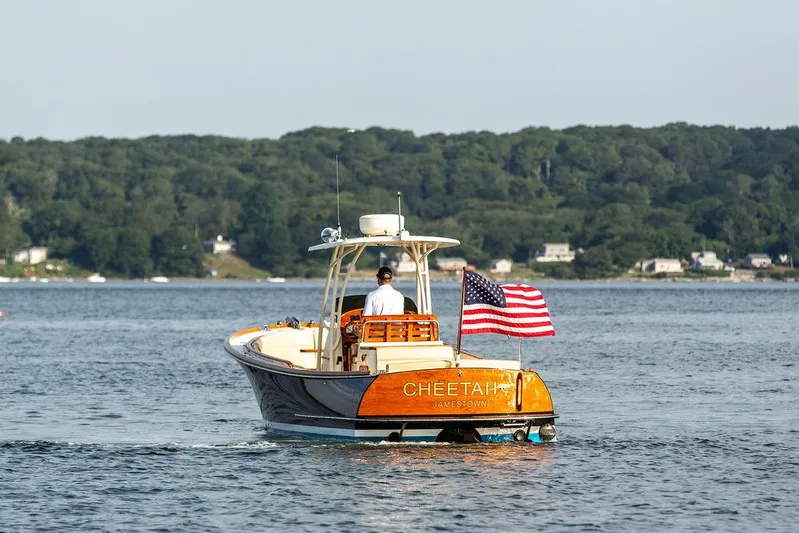 Cheetah Yacht Photos Pics 2014 Hinckley T29 CC boat on water, American flag, scenic background.