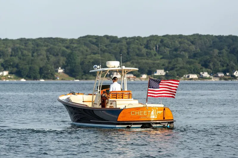 Cheetah Yacht Photos Pics 2014 Hinckley T29 CC boat on water with American flag, scenic background.