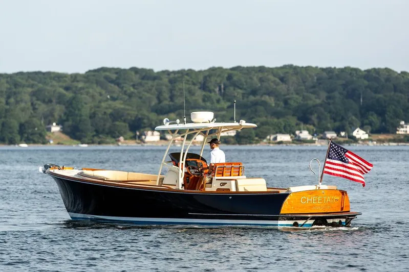 Cheetah Yacht Photos Pics 2014 Hinckley T29 CC boat on water, American flag, scenic background.