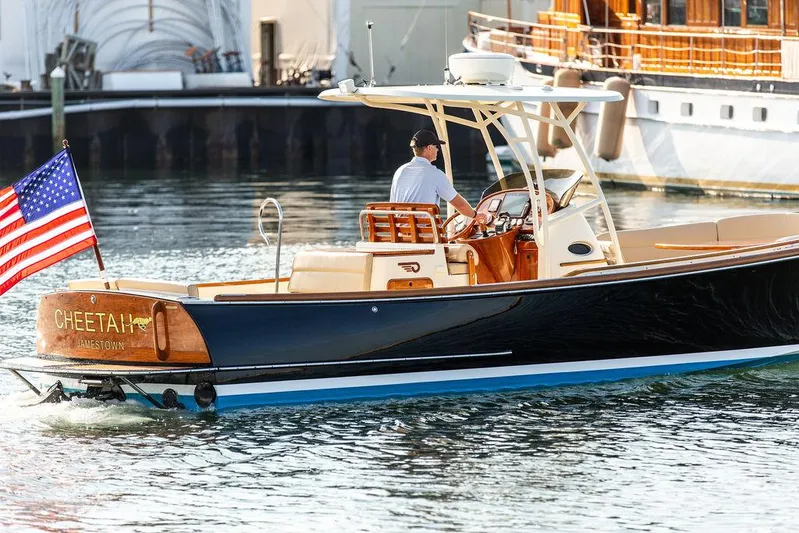 Cheetah Yacht Photos Pics 2014 Hinckley T29 CC boat with American flag, cruising in a marina.