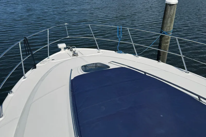  Yacht Photos Pics 2005 Sea Ray 420 Sundancer yacht bow view with blue cover and railing.