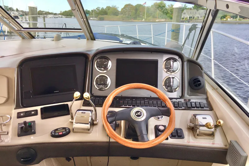  Yacht Photos Pics 2005 Sea Ray 420 Sundancer helm with wooden steering wheel and modern controls.