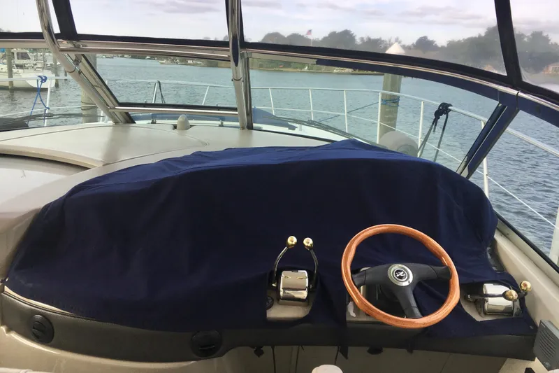  Yacht Photos Pics 2005 Sea Ray 420 Sundancer helm with covered dashboard and wooden steering wheel.