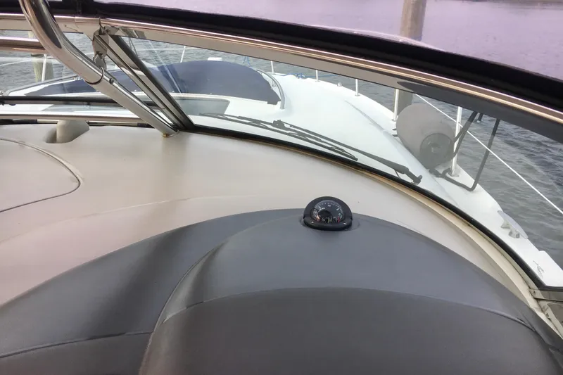  Yacht Photos Pics 2005 Sea Ray 420 Sundancer cockpit view with compass, overlooking the bow and water.