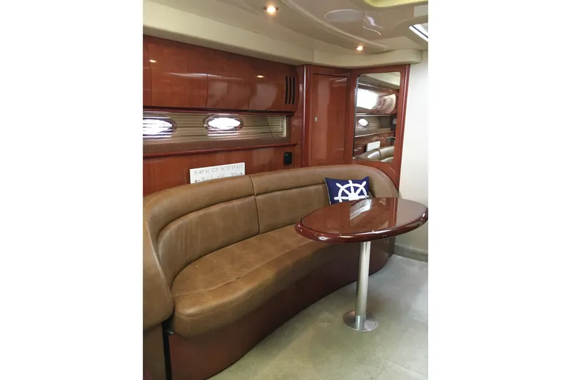  Yacht Photos Pics Luxurious interior of 2005 Sea Ray 420 Sundancer yacht with leather seating and wooden table.
