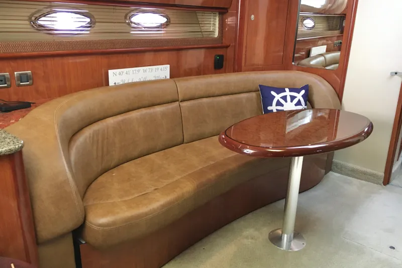  Yacht Photos Pics Luxurious interior of 2005 Sea Ray 420 Sundancer with leather seating and wooden table.