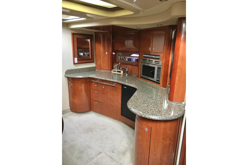  Yacht Photos Pics Luxurious 2005 Sea Ray 420 Sundancer yacht kitchen with granite countertops and wood cabinetry.