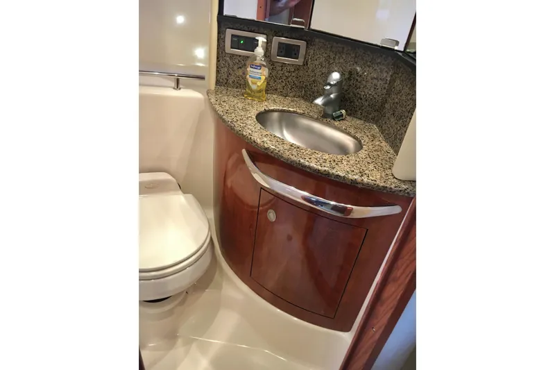  Yacht Photos Pics Luxurious bathroom in 2005 Sea Ray 420 Sundancer yacht with granite countertop and modern fixtures.
