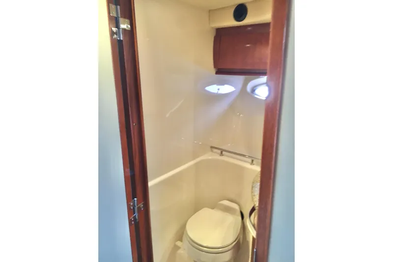  Yacht Photos Pics 2005 Sea Ray 420 Sundancer yacht bathroom with wooden door and compact design.