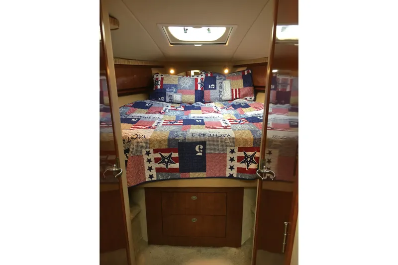  Yacht Photos Pics Cozy cabin interior of 2005 Sea Ray 420 Sundancer with colorful patchwork quilt.