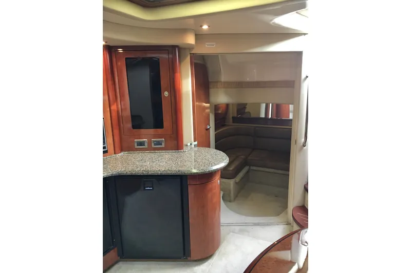  Yacht Photos Pics Interior of 2005 Sea Ray 420 Sundancer yacht with wood cabinetry and seating area.