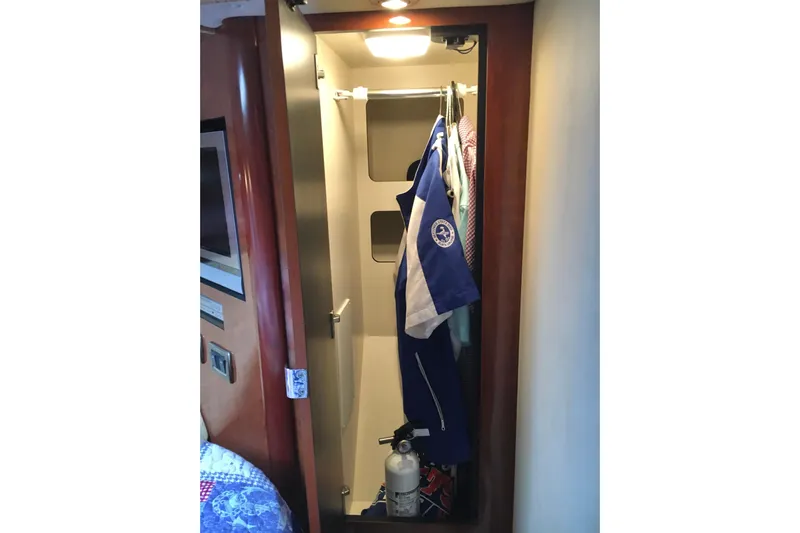  Yacht Photos Pics Closet interior on 2005 Sea Ray 420 Sundancer yacht with hanging clothes and fire extinguisher.