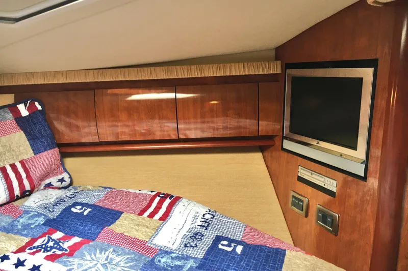  Yacht Photos Pics Cozy cabin interior of 2005 Sea Ray 420 Sundancer with TV and colorful bedding.
