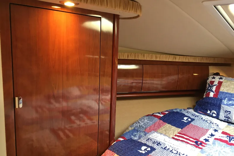  Yacht Photos Pics Luxurious 2005 Sea Ray 420 Sundancer cabin with wooden cabinetry and nautical-themed bedding.