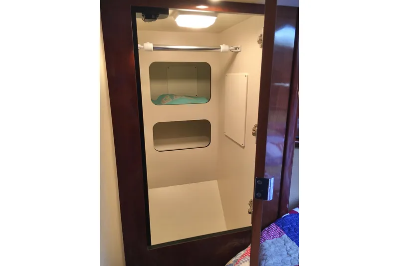  Yacht Photos Pics Interior closet of 2005 Sea Ray 420 Sundancer yacht with shelves and hanging rod.