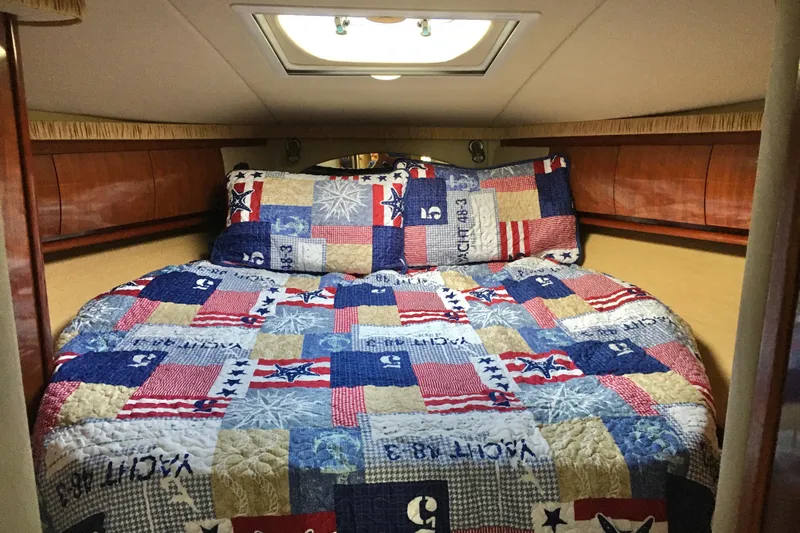  Yacht Photos Pics Cozy cabin interior of 2005 Sea Ray 420 Sundancer with nautical-themed bedding.