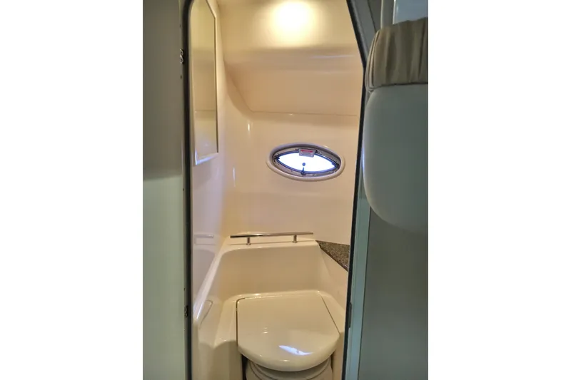  Yacht Photos Pics 2005 Sea Ray 420 Sundancer bathroom interior with porthole window and compact design.