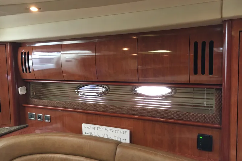  Yacht Photos Pics Interior of 2005 Sea Ray 420 Sundancer yacht with wood cabinetry and porthole window.