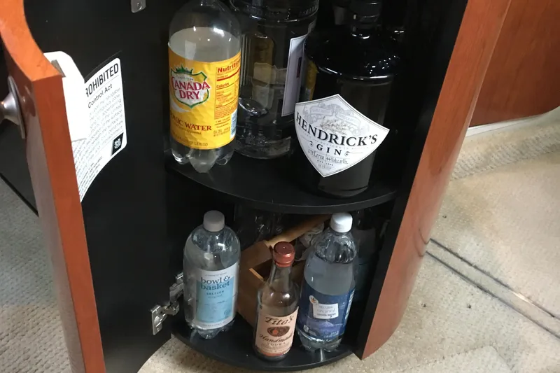  Yacht Photos Pics Bar cabinet on 2005 Sea Ray 420 Sundancer with assorted beverages and tonic water.