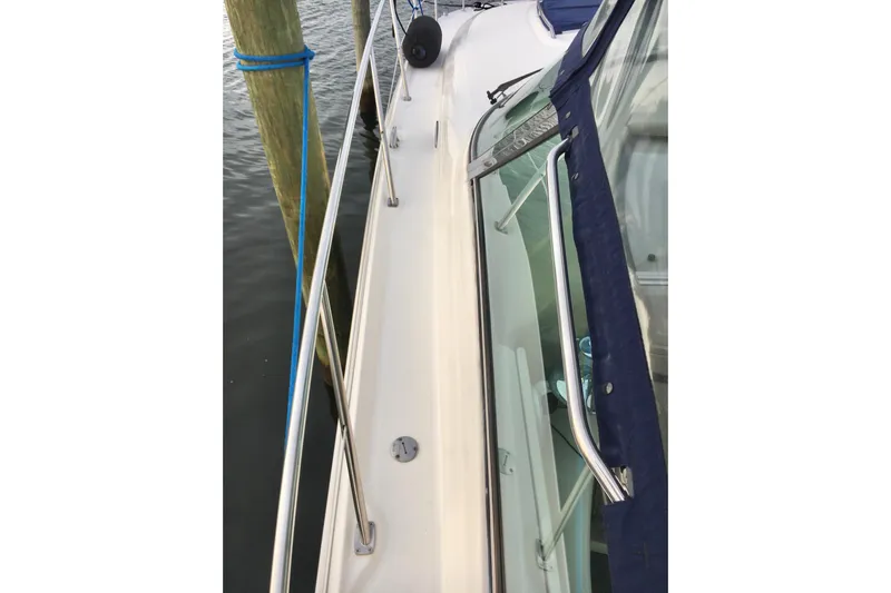  Yacht Photos Pics 2005 Sea Ray 420 Sundancer yacht deck with railing and docked at marina.