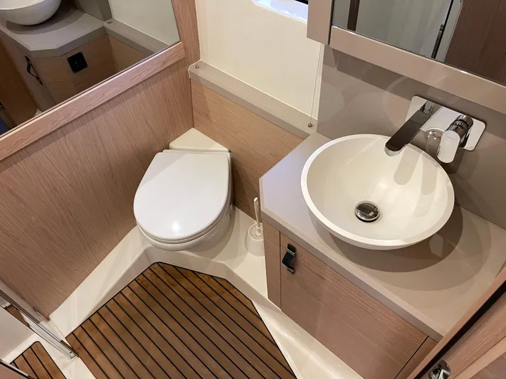  Yacht Photos Pics Luxury bathroom in 2022 Beneteau Monte Carlo 52 yacht with modern sink and toilet.