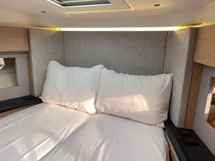  Yacht Photos Pics Luxurious bedroom interior of 2022 Beneteau Monte Carlo 52 yacht with plush bedding.