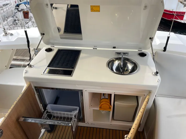  Yacht Photos Pics Outdoor kitchenette on 2022 Beneteau Monte Carlo 52 yacht with sink and grill.