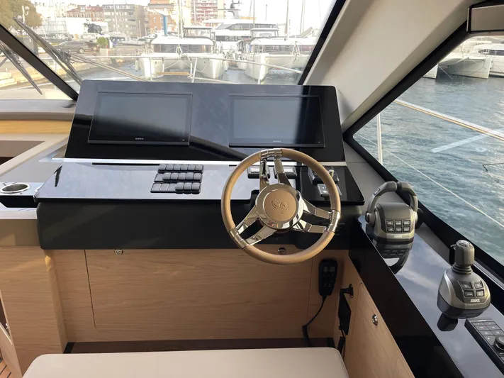  Yacht Photos Pics Helm of 2022 Beneteau Monte Carlo 52 yacht with modern controls and steering wheel.