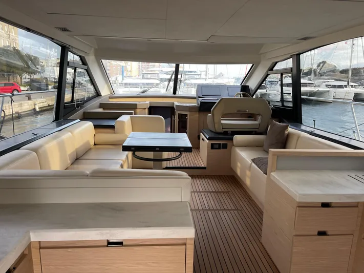  Yacht Photos Pics Luxurious interior of 2022 Beneteau Monte Carlo 52 yacht with modern furnishings and panoramic windows.