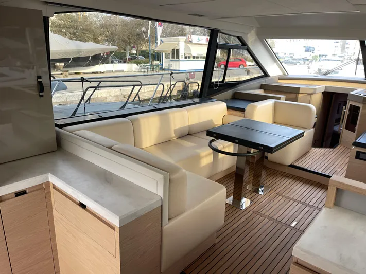  Yacht Photos Pics Luxurious interior of 2022 Beneteau Monte Carlo 52 yacht with elegant seating and modern design.