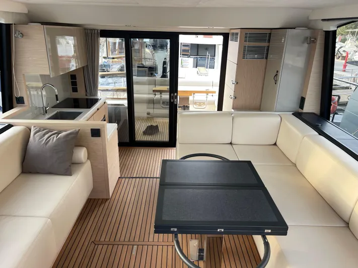  Yacht Photos Pics Luxurious interior of 2022 Beneteau Monte Carlo 52 yacht with modern furnishings and sleek design.