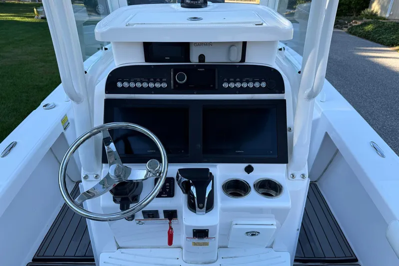  Yacht Photos Pics 2023 Everglades 243 Center Console boat dashboard with steering wheel and dual displays.