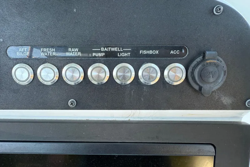  Yacht Photos Pics Control panel of 2023 Everglades 243 Center Console boat with labeled switches.