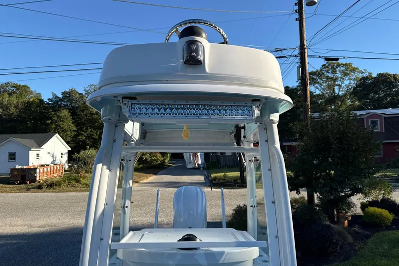  Yacht Photos Pics 2023 Everglades 243 Center Console boat with T-top and LED lights in a suburban setting.