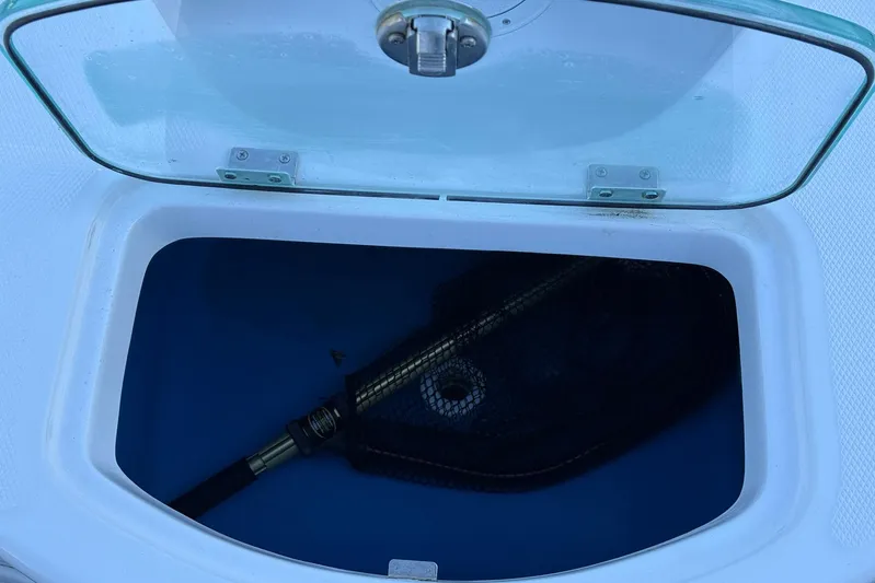  Yacht Photos Pics Open storage compartment on 2023 Everglades 243 Center Console boat with fishing net inside.