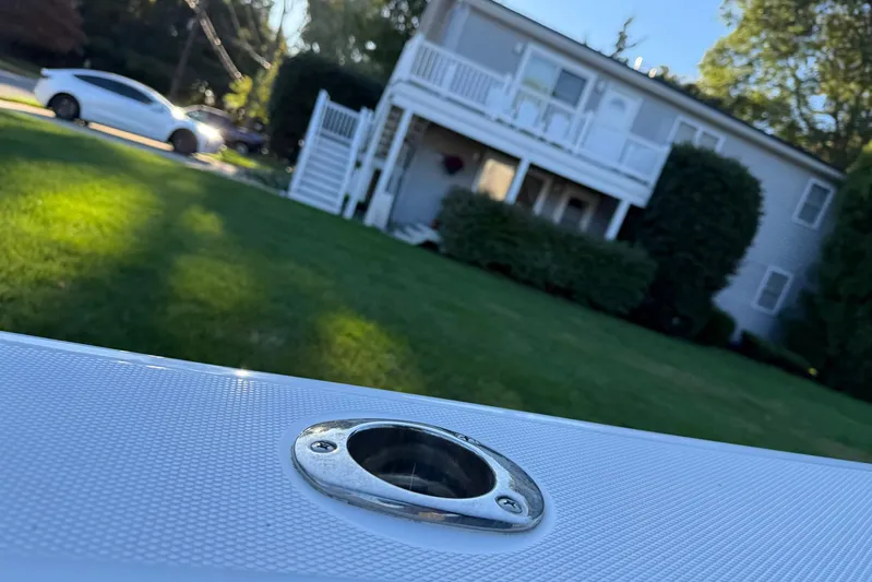  Yacht Photos Pics 2023 Everglades 243 Center Console boat detail with house and car in background.