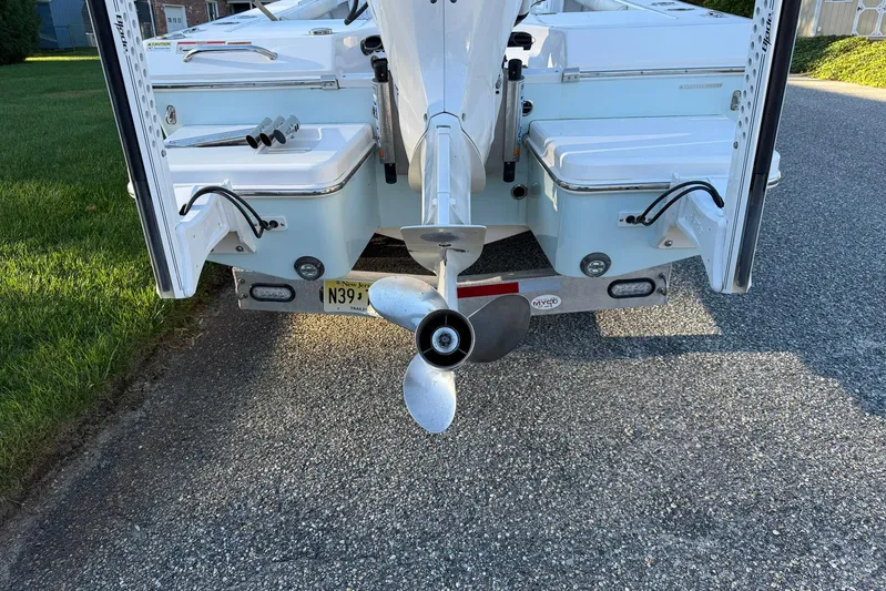  Yacht Photos Pics 2023 Everglades 243 Center Console boat rear view with propeller and trailer.
