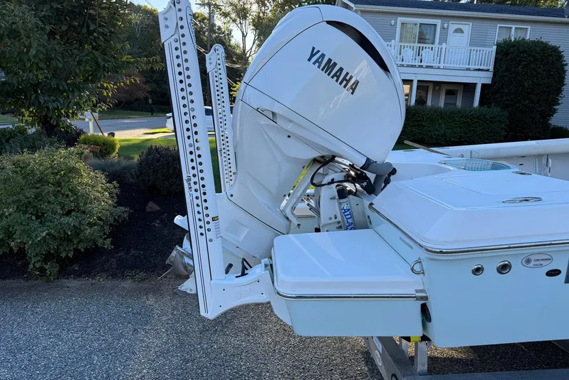  Yacht Photos Pics 2023 Everglades 243 Center Console boat with Yamaha outboard motor in residential setting.
