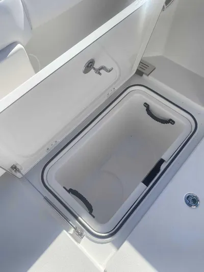 Cat Outta Hell Yacht Photos Pics Open storage compartment on 2025 Caymas 34 CT boat, featuring a sleek white interior.