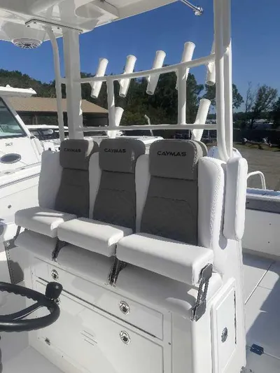 Black Label Marine Yacht Photos Pics 2025 Caymas 34 CT boat seating with rod holders, featuring sleek white and gray design.