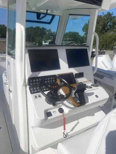 Cat Outta Hell Yacht Photos Pics 2025 Caymas 34 CT boat cockpit with dual screens and steering wheel.