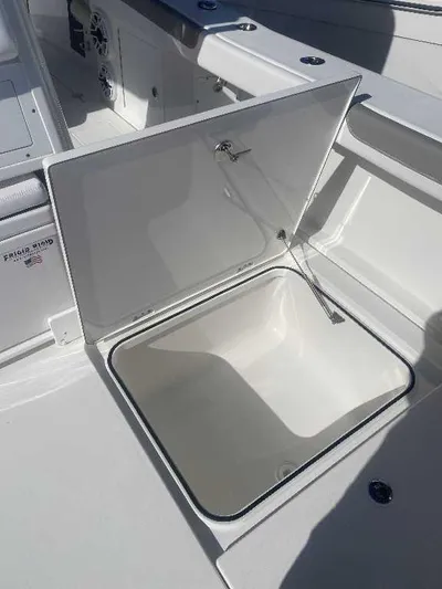 Black Label Marine Yacht Photos Pics Open storage compartment on 2025 Caymas 34 CT boat, showcasing spacious interior.