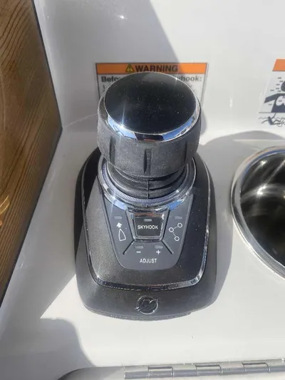 Cat Outta Hell Yacht Photos Pics Joystick control on 2025 Caymas 34 CT boat dashboard with Skyhook feature.