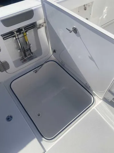 Cat Outta Hell Yacht Photos Pics Open storage compartment on 2025 Caymas 34 CT boat, showcasing interior space.