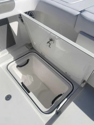 Cat Outta Hell Yacht Photos Pics 2025 Caymas 34 CT boat storage compartment with open lid, showcasing interior space.