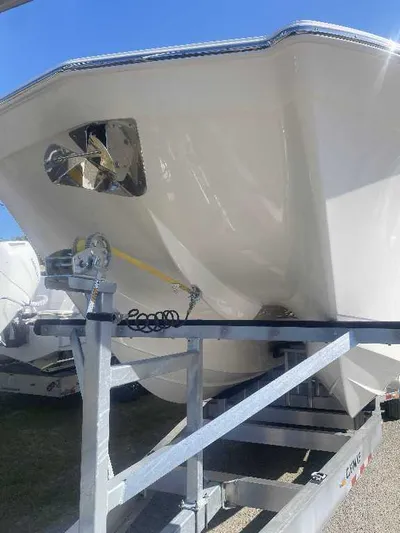 Black Label Marine Yacht Photos Pics 2025 Caymas 34 CT boat on trailer, viewed from the front, under clear blue sky.