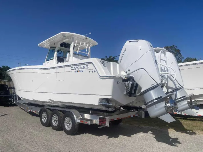 Black Label Marine Yacht Photos Pics 2025 Caymas 34 CT boat on trailer with dual engines, parked outdoors.