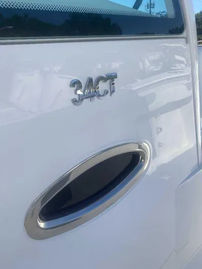 Cat Outta Hell Yacht Photos Pics 2025 Caymas 34 CT boat exterior with model emblem and sleek design.