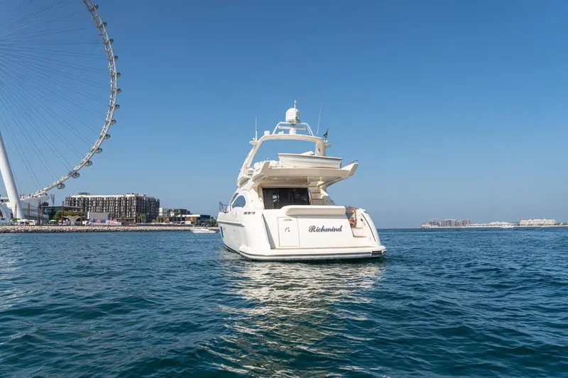 Richmind Yacht Photos Pics 2007 Azimut 68E yacht on water near a large Ferris wheel.